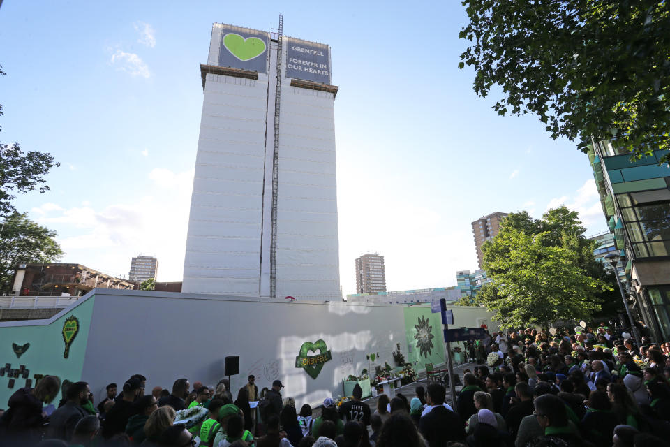 Family and friends of the 72 people who lost their lives in the Grenfell Tower block fire gather at the scene in June. (PA)