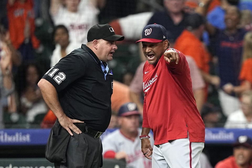 Washington Nationals manager Dave Martinez, right, argues with home plate umpire Jeremy Riggs after the final play during the ninth inning of a baseball game against the Houston Astros Wednesday, June 14, 2023, in Houston. The Astros won 5-4. (AP Photo/David J. Phillip)