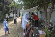 A health worker takes a nasal swab sample to test for COVID-19 at a government health center in Hyderabad, India, Monday, Aug. 31, 2020. India has now reported more than 75,000 infections for four straight days, one of the highest in the world, just as the government began easing restrictions to help the battered economy. (AP Photo/Mahesh Kumar A.)