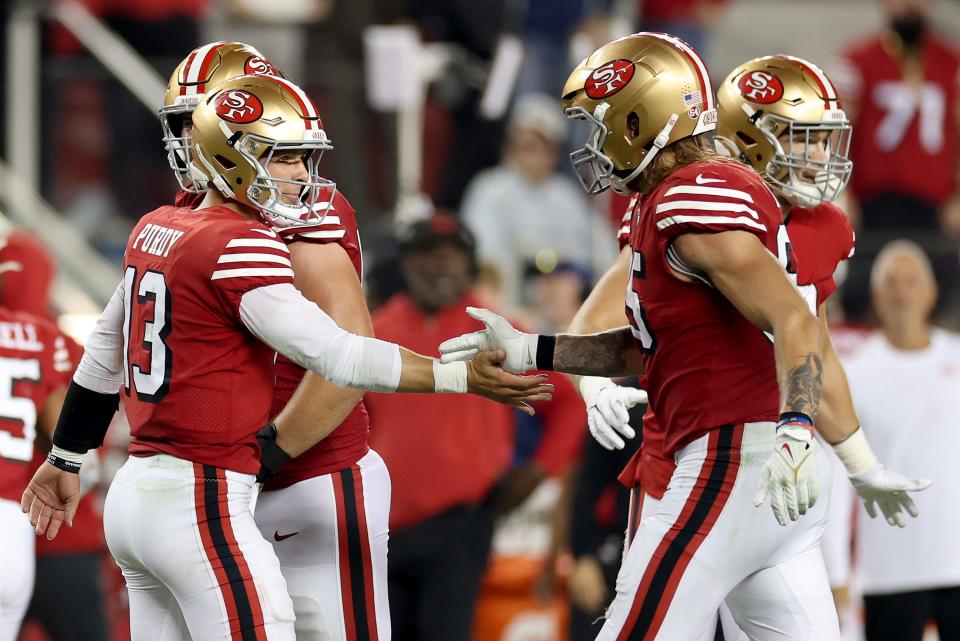 Brock Purdy #13 and George Kittle #85 of the San Francisco 49ers celebrate a touchdown scored by Deebo Samuel #19 against the New York Giants during the fourth quarter in the game at Levi's Stadium on Sept. 21, 2023, in Santa Clara, California.