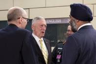 U.S. Secretary of Defense Jim Mattis, center, speaks with Canadian Defense Minister Harjit Singh Sajjan, right, during a meeting of the NATO-Georgia Council at NATO headquarters in Brussels on Thursday, Feb. 16, 2017. U.S. Defense Secretary Jim Mattis on Wednesday told NATO ministers that the alliance is "a fundamental bedrock for the United States" while at the same time demanding an increased financial commitment from the 27 other alliance members. (AP Photo/Virginia Mayo)
