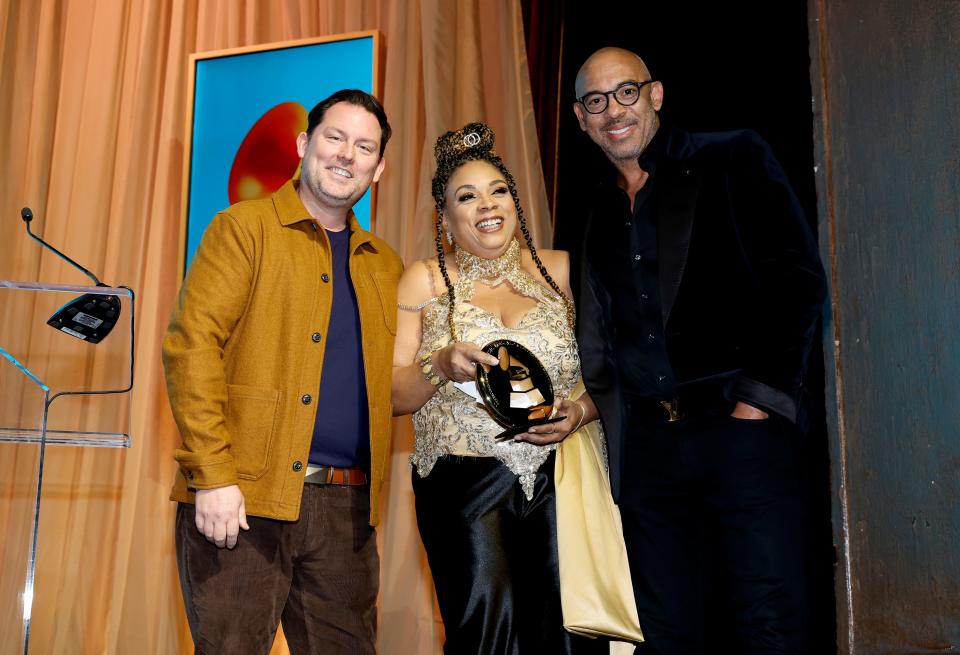 GRAMMY Museum President/CEO Michael Sticka, left, Pamela Dawson, center, and CEO of The Recording Academy and MusiCares Harvey Mason Jr. pose onstage during the Special Merit Awards Ceremony & 65th Annual GRAMMY Nominees Reception in Los Angeles.