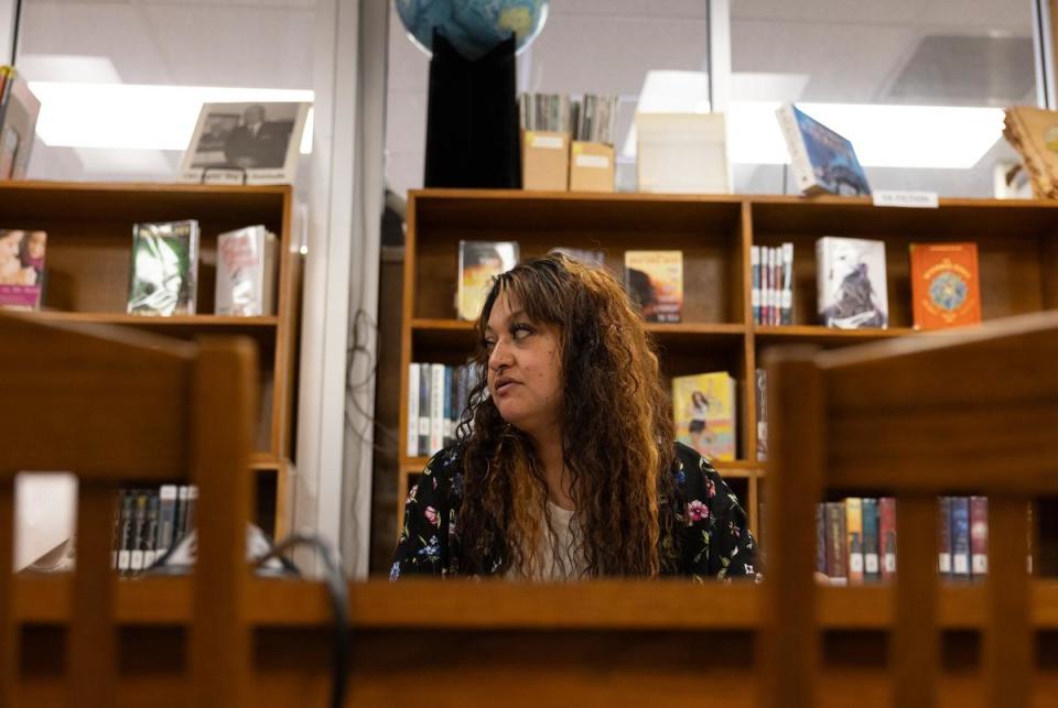 Britany Flores listens while her patron Jalen speaks to her in the Smithville Public Library in Smithville, Texas on Mar. 11, 2024. Flores has a number of patrons that she sees as part of program where she is promoting mental health.