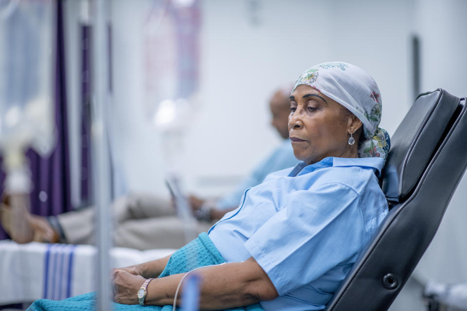 An African American woman in a headscarf in a hospital.