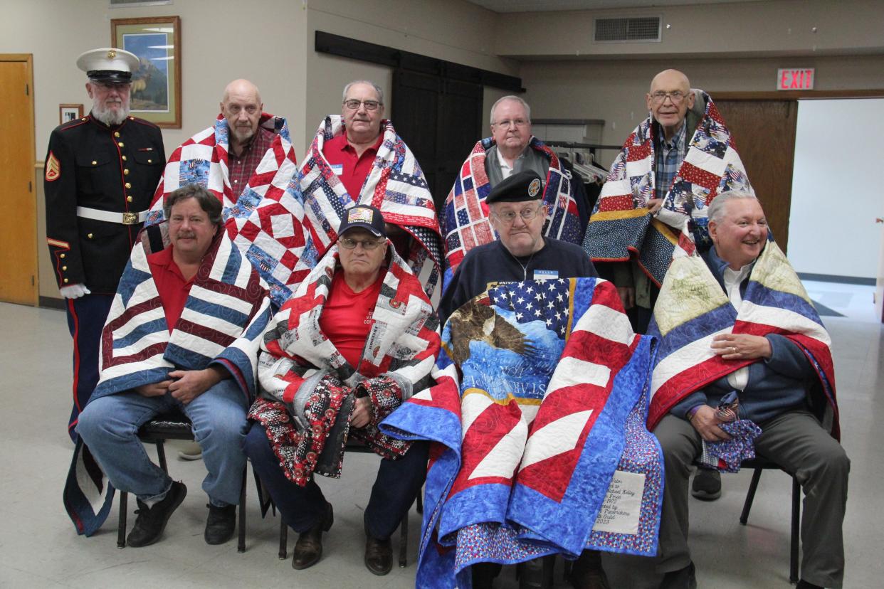 Veterans pose for a photo with their Quilts of Valor during a presentation hosted by the Perry Piecemakers Quilt Guild on Friday, Nov. 10, 2023, at the Perry Elks Lodge.