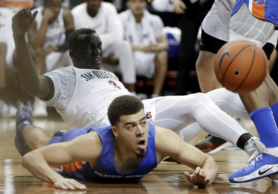 Boise State's Alex Hobbs (34) and San Diego State's Aguek Arop (3) go for a loose ball during the second half of an NCAA college basketball game in the Mountain West Conference men's tournament Friday, March 6, 2020, in Las Vegas. (AP Photo/Isaac Brekken)