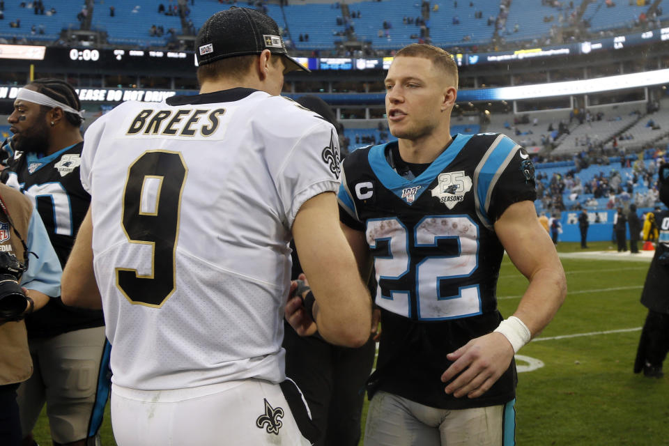 New Orleans Saints quarterback Drew Brees (9) and Carolina Panthers running back Christian McCaffrey (22) speak following an NFL football game in Charlotte, N.C., Sunday, Dec. 29, 2019. (AP Photo/Brian Blanco)