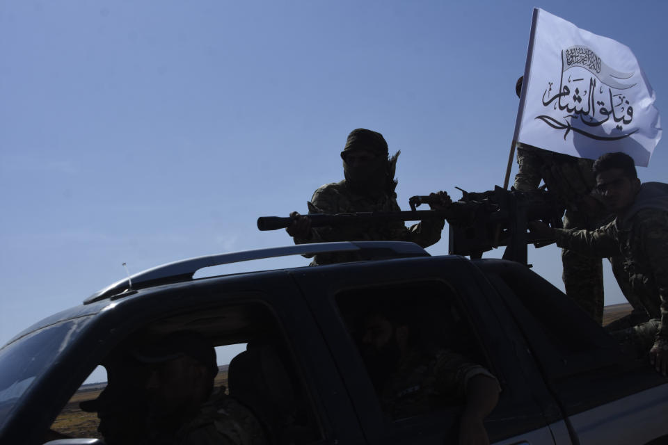 Turkey-backed FSA fighters are heading toward Syrian town of Tal Abyad from Turkish border town of Akcakale, Turkey, Thursday, Oct. 10, 2019. Turkish President Recep Tayyip Erdogan says that there have been 109 "terrorists killed" — a reference to Syrian Kurdish fighters — since Ankara launched an offensive into Syria the previous day. (DHA via AP)