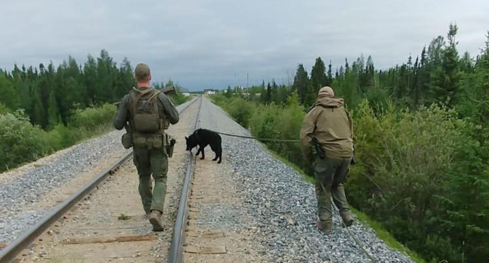 Searchers on foot in the hunt for suspects in the Canadian murders of an Australian man and his US girlfriend.