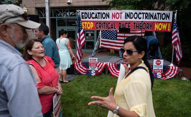 People talk before the start of a June 12 rally in Leesburg, Virginia, against 