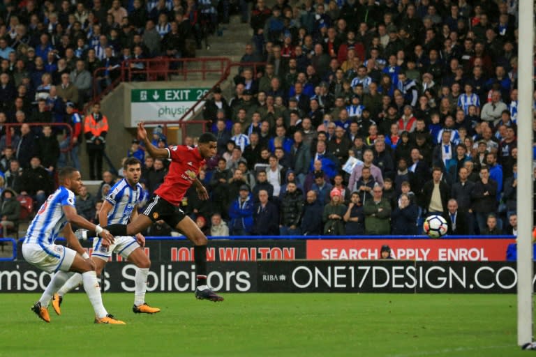 Manchester United's Marcus Rashford heads their first goal during their match against Huddersfield Town the John Smith's stadium in Huddersfield, northern England on October 21, 2017