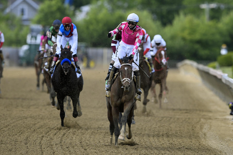 Flavien Prat atop Rombauer, center, reacts after winning the Preakness Stakes horse race at Pimlico Race Course, Saturday, May 15, 2021, in Baltimore. (AP Photo/Nick Wass)