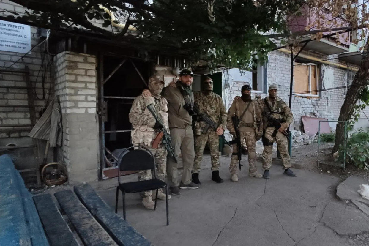 This photo posted by pro-Kremlin journalist Sergey Sreda, second from left, reveals at the top left the address of a building believed to house mercenaries fighting for Russia in Ukraine. The building was bombed Sunday.