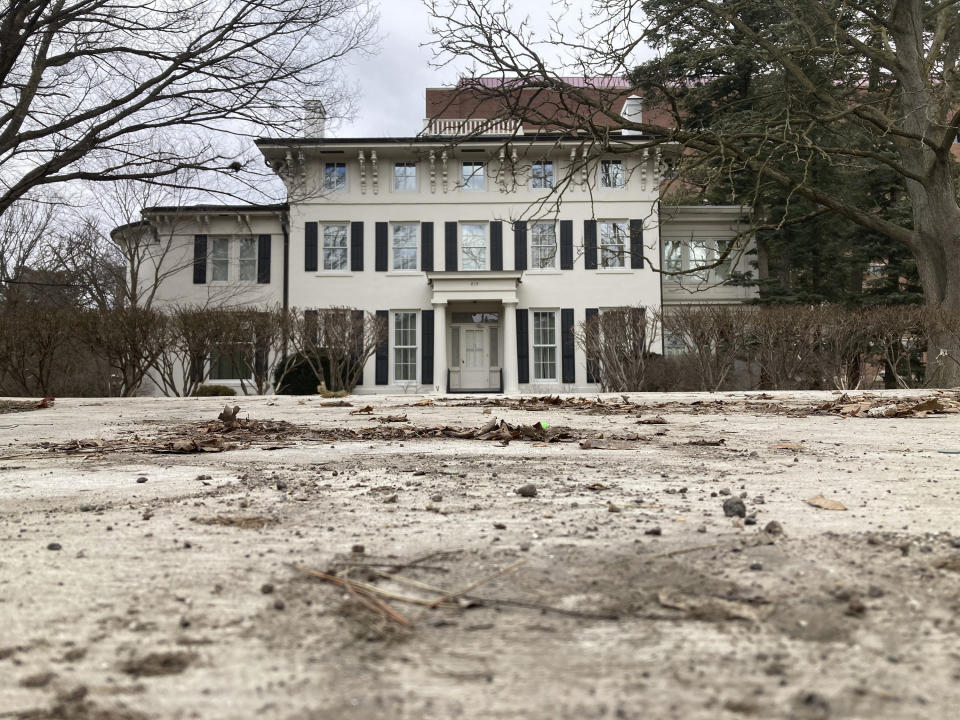 The home of the University of Michigan's president is seen on Tuesday, March 8, 2022, in Ann Arbor, Mich. The school says it removed a camper, tent, signs and other items that had stood in front of the president's home for months. They represented a former Michigan football player's protest against the university's handling of sex abuse allegations involving a campus doctor. (AP Photo/Mike Householder)