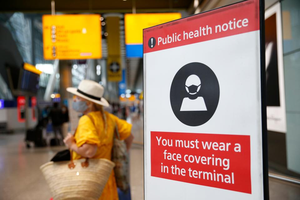 A public health notice is displayed at the International Arrivals gate at London's Heathrow Airport on Aug. 7, 2021.