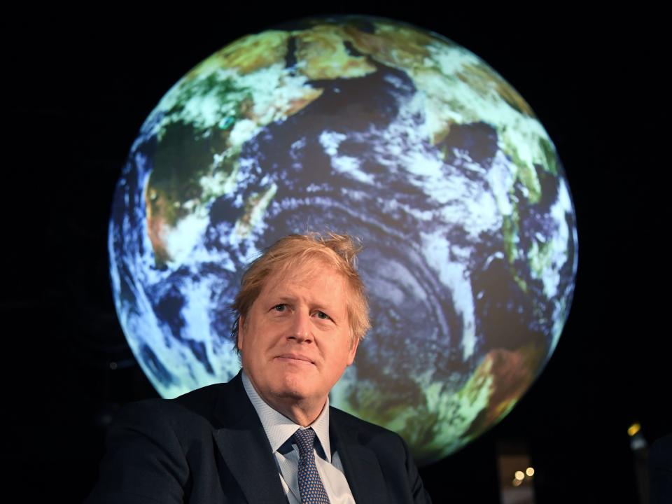 Britain's Prime Minister Boris Johnson reacts during an event to launch the United Nations' Climate Change conference, COP26, in central London on February 4, 2020. - Britain will bring forward a ban on sales of new petrol and diesel vehicles to 2035, including hybrids, Prime Minister Boris Johnson was to announce on Tuesday. Johnson was to make the announcement at an event launching the 2019 United Nations Climate Change conference, COP26, which will be held in Glasgow in November. (Photo by Jeremy Selwyn / POOL / AFP) (Photo by JEREMY SELWYN/POOL/AFP via Getty Images)