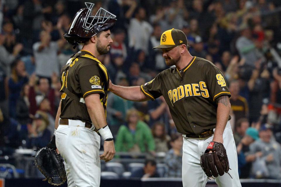 May 31, 2019; San Diego, CA, USA; San Diego Padres relief pitcher Kirby Yates (right) and catcher Austin Hedges (18) celebrate a 5-2 win over the Miami Marlins at Petco Park. Mandatory Credit: Jake Roth-USA TODAY Sports