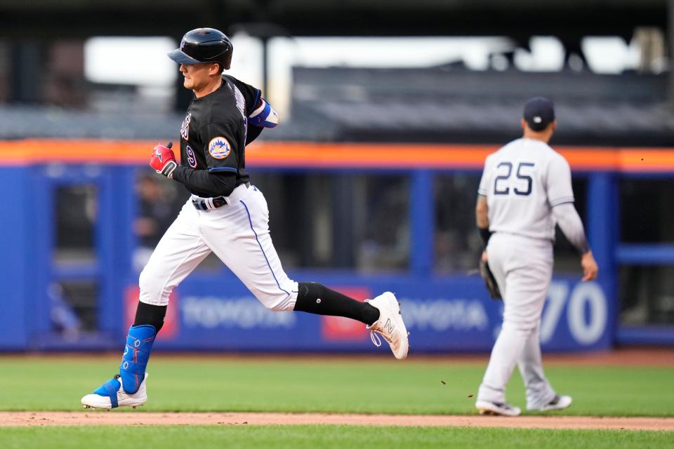 New York Mets' Mark Canha passes New York Yankees' Gleyber Torres (25) as he runs the bases after hitting a home run during the first inning of a baseball game Tuesday, June 13, 2023, in New York. (AP Photo/Frank Franklin II)