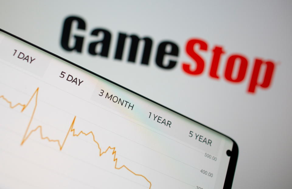 GameStop stock graph is seen in front of the company's logo in this illustration taken February 2, 2021. REUTERS/Dado Ruvic/Illustration