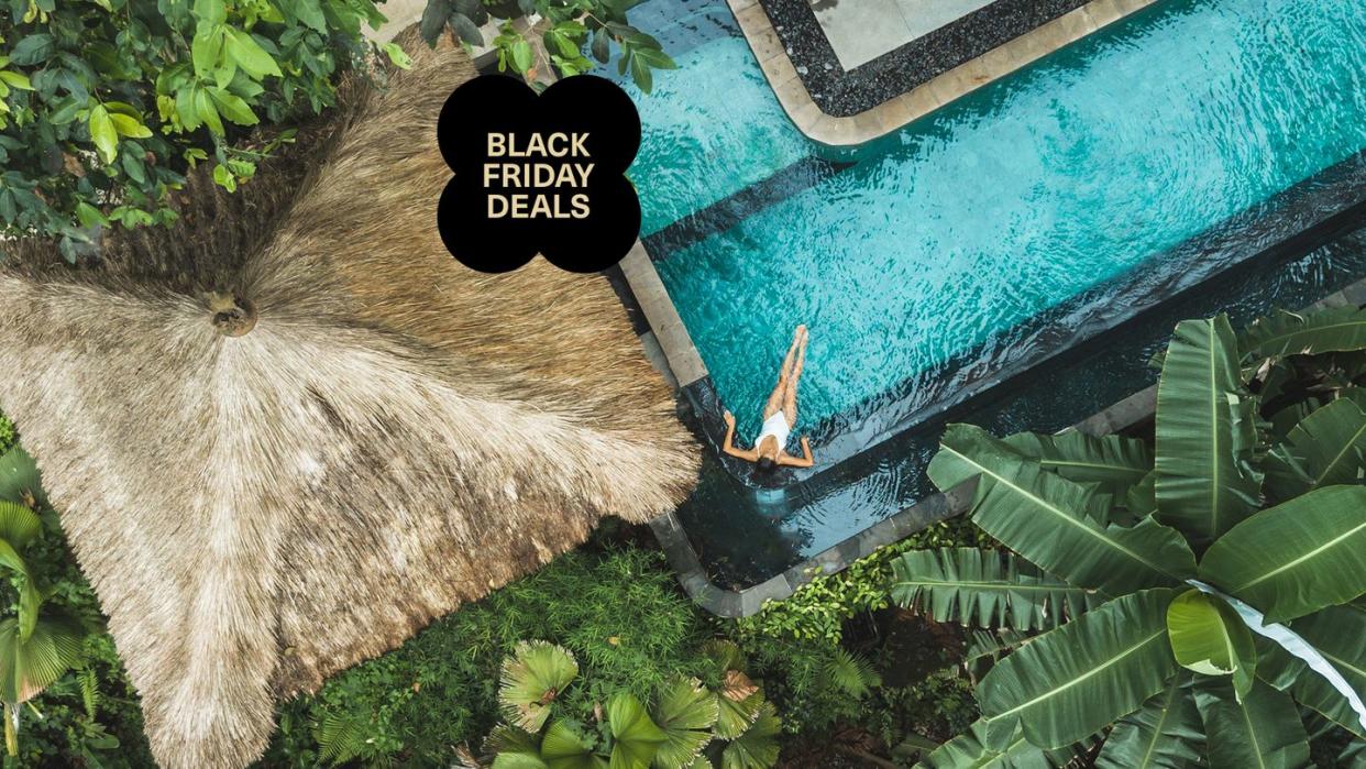 a woman soaking in a tropical pool, aerial view