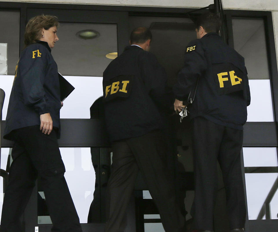 FBI agents enter Trenton City Hall, Thursday, July 19, 2012, in Trenton, N.J. The agents raid comes a day after FBI agents searched the home of Mayor Tony Mack. The mayor on Wednesday denied wrongdoing after the FBI spent the overnight hours searching his home, and the homes of his brother, Ralphiel Mack, and businessman Joseph Giorgianni, a campaign donor who is a convicted sex offender. (AP Photo/Julio Cortez)