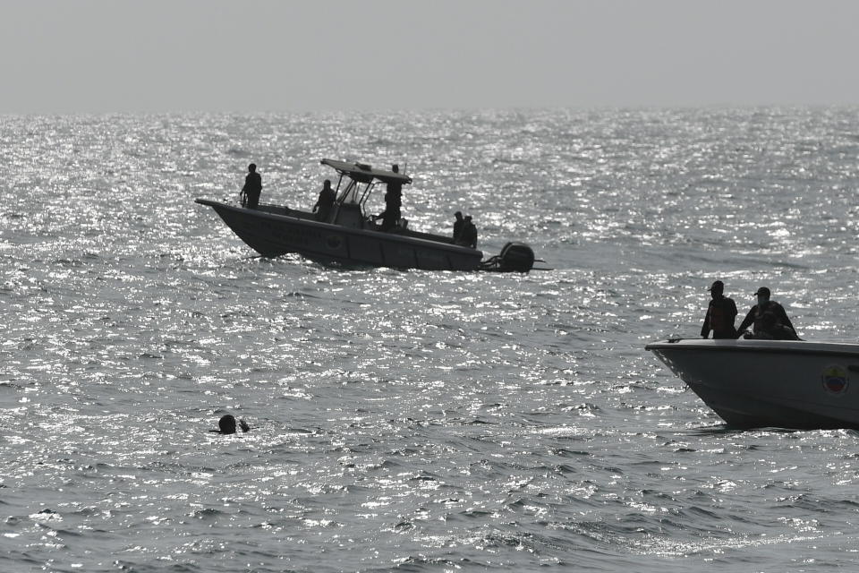 Security forces investigate near the shore in the port city of La Guaira, Venezuela, Sunday, May 3, 2020. Interior Minister Nestor Reverol said on state television that security forces overcame before dawn Sunday an armed maritime incursion with speedboats from neighboring Colombia in which several attackers were killed and others detained. (AP Photo/Matias Delacroix)