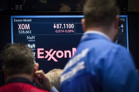 Traders gather at the post that trades ExxonMobil on the floor of the New York Stock Exchange March 5, 2015. REUTERS/Brendan McDermid
