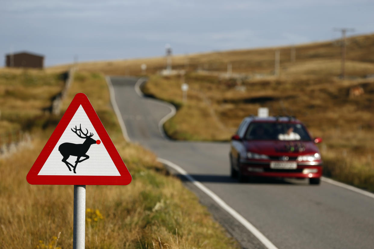 A road sign warning motorists to be careful of deer crossing on South Uist. (PA)