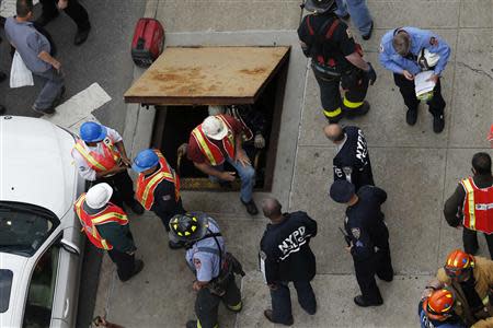 Metropolitan Transportation Authority (MTA) workers exit an emergency staircase after evacuating from a derailed F train in Woodside, New York, May 2, 2014. REUTERS/Eduardo Munoz