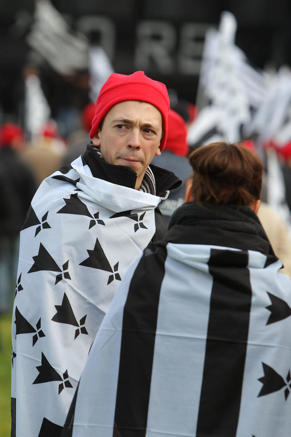 REMOVES THE REFERENCE TO THE NUMBER OF YEARS OF THE ADMINISTRATIVE REGIONS FILE - In this Nov.30, 2013 file photo, protesters wearing red hats and flags of Brittany take part a demonstration against job losses and against the government’s “eco-tax”, a controversial environmental tax on heavy goods vehicles, in Carhaix, Brittany. France’s administrative regions have been part of the identity of citizens of the sprawling and diverse country. Now, merging some of them is seen as a logical way to save money on bureaucracy, and the French support it _ as long as it’s someone else’s region. (AP Photo/David Vincent, FILE)