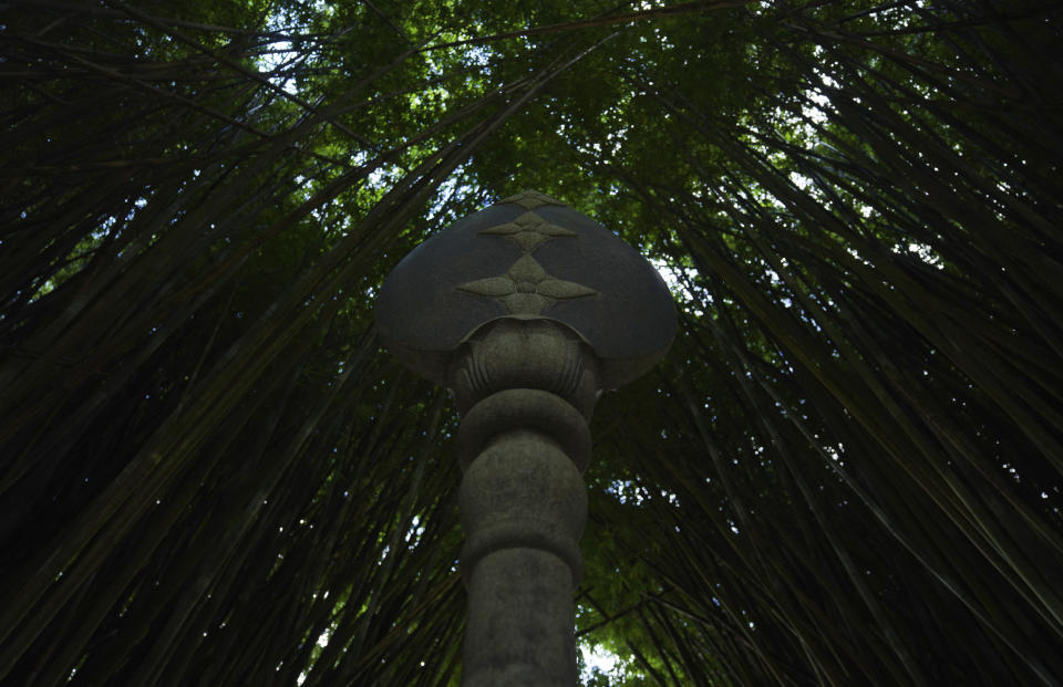 A statue of a spear, which is the weapon of Lord Muruga, the Hindu god of war, stands amidst a cave of bamboo, at Kauai's Hindu Monastery, on July 10, 2023, in Kapaa, Hawaii. (AP Photo/Jessie Wardarski)