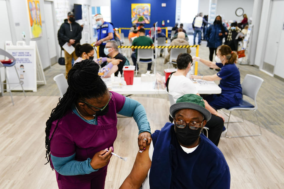 Nurse Sheena Davis administers a dose of a Moderna COVID-19 vaccine during a vaccination clinic at the Keystone First Wellness Center in Chester, Pa., Wednesday, Dec. 15, 2021. (AP Photo/Matt Rourke)