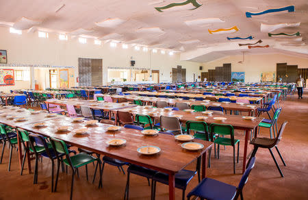 Chairs and tables are arranged in the dinning hall at the Agahozo-Shalom Youth Village (ASYV) built to rehabilitate children who lost their families in the 1994 Rwandan genocide, in Rwamagana, Eastern Province of Rwanda April 1, 2019. Picture taken April 1, 2019. REUTERS/Jean Bizimana