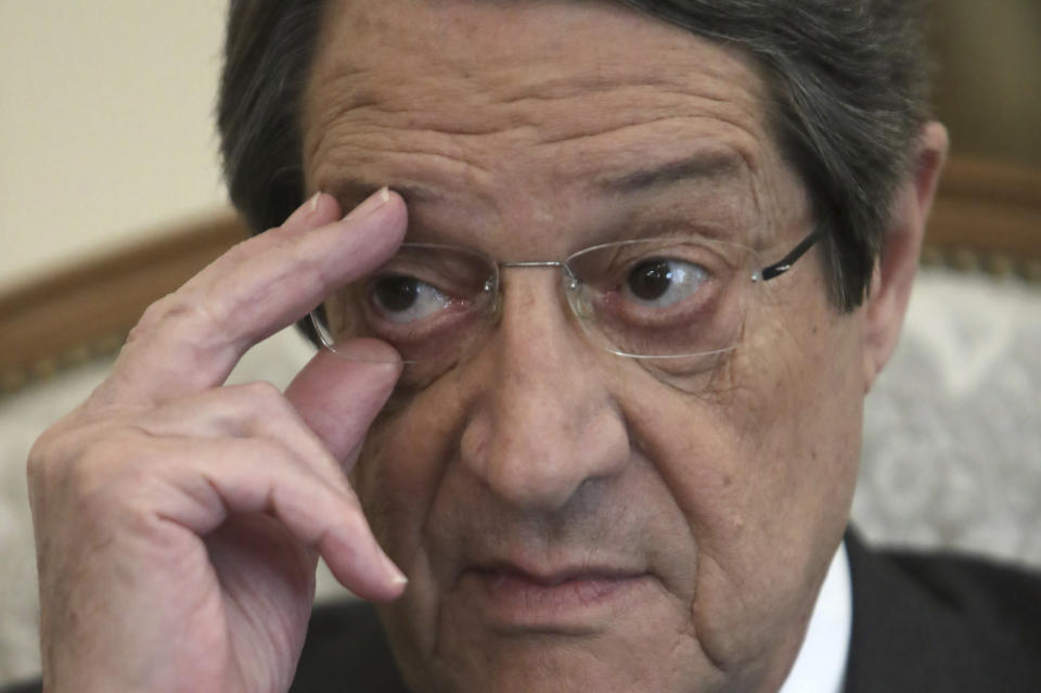 Cyprus' president Nicos Anastasiades adjusts his glasses during an interview with Associate Press at the presidential palace in capital Nicosia, Cyprus, Tuesday Sept. 17, 2019. Anastasiades says Turkey's "obsession" to permanently station troops, secure military intervention rights and extend its influence over Turkish Cypriots in any peace deal is fanning fears that it wants to turn the island into a "protectorate." (AP Photo/Petros Karadjias)
