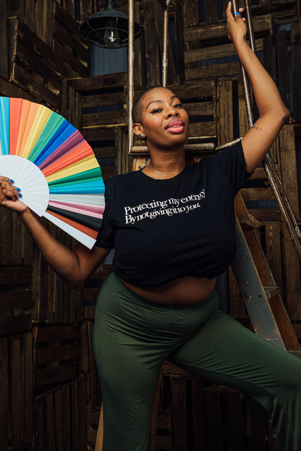 Woman posing with rainbow-colored fan