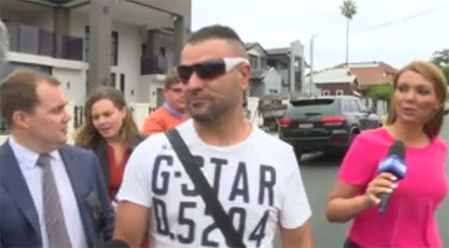 A man was questioned my media outside one of the homes which was raided by police today. Photo: AAP.