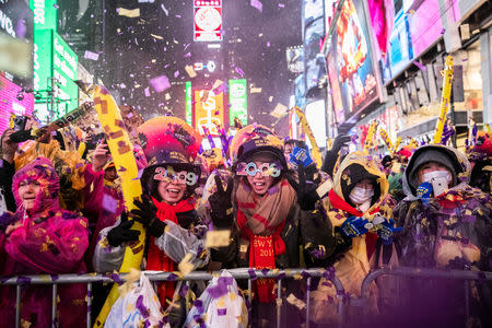 Revelers celebrate New Year's Eve in Times Square in the Manhattan borough of New York, U.S., December 31, 2018. REUTERS/Jeenah Moon