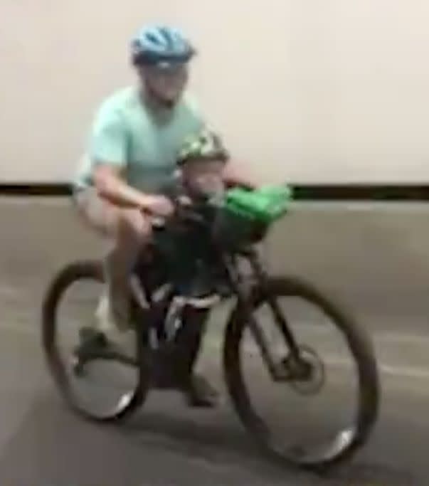 The man on a bike with a child was filmed pedalling in Sydney's Lane Cove Tunnel as other drivers passed by.