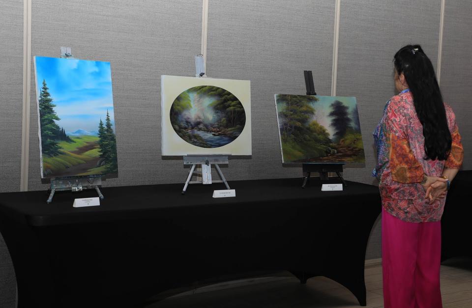 Guests who attended the The Joy Continues, a Bob Ross Workshop live-painting event, viewed more than 30 of Ross' original paintings at the Brannon Center in New Smyrna Beach on Thursday, April 4, 2024.