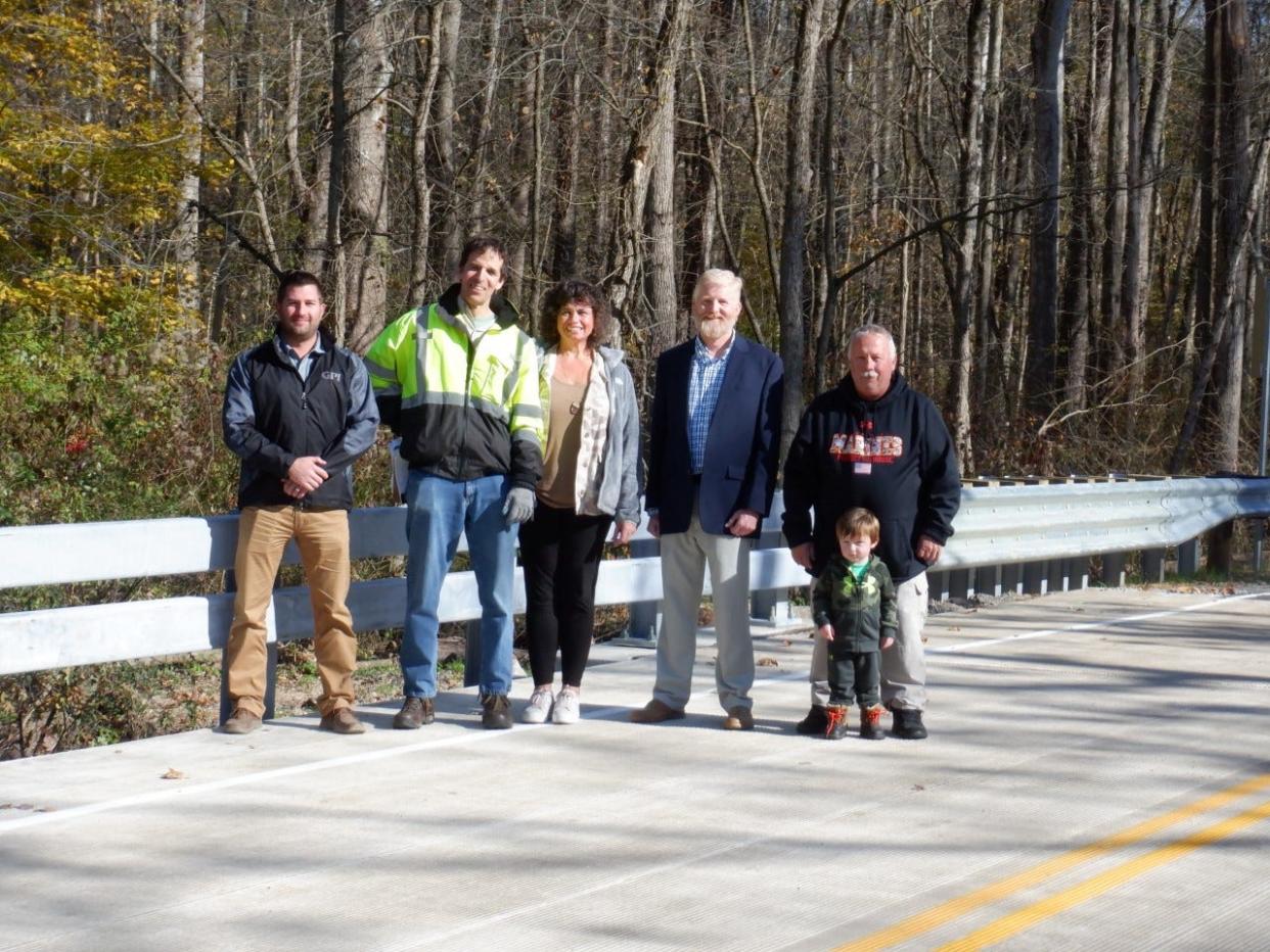 The Silica Sand Road bridge in Windham Township over Eagle Creek was recently reopened to traffic after being closed for reconstruction for the past several months. On hand for the opening were, from left, Mike Kline, representing GPI, the construction inspection company hired by the county; James Kusner, bridge engineer for Portage County; Sabrina Christian Bennett, Portage County commissioner; Larry Jenkins, chief deputy Portage County engineer; and Dan Burns, Windham Township Trustee, with his grandson, Dawson Prasky.