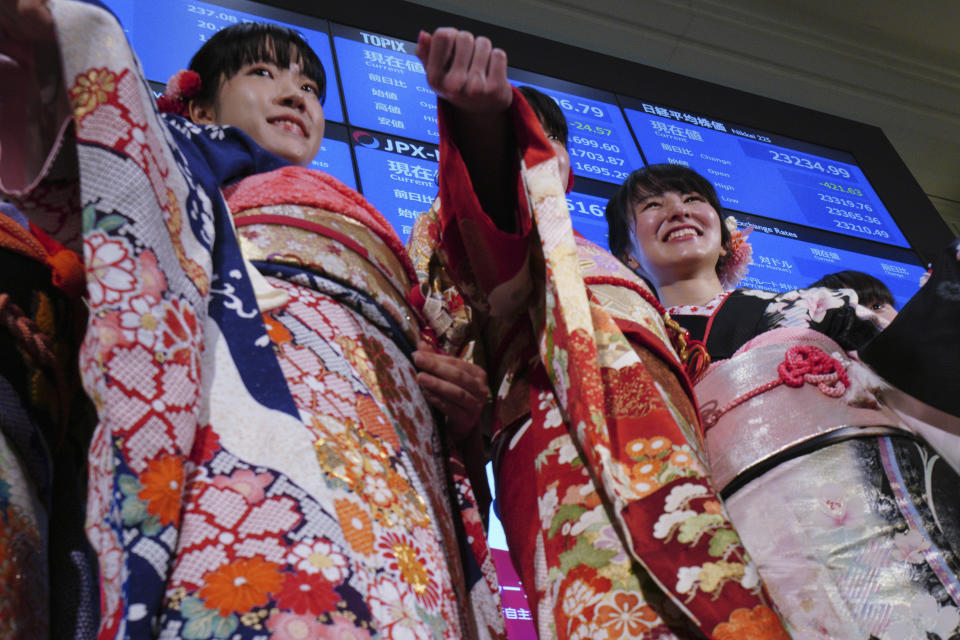 Kimono-clad employees of the Tokyo Stock Exchange and models walk out from the stage during a ceremony marking the start of this year's trading in Tokyo Monday, Jan. 6, 2020, in Tokyo. (AP Photo/Eugene Hoshiko)