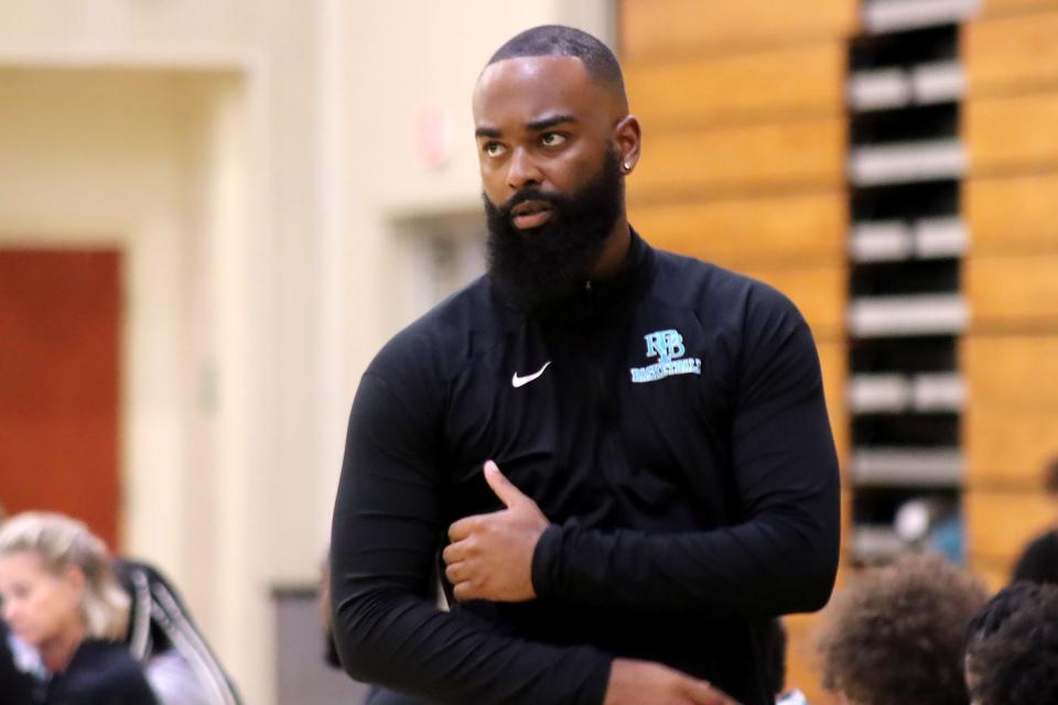 Royal Palm Beach basketball coach Deonte Savage takes a look at the scoreboard in the Wildcats’ 73-66 season opener victory at Atlantic High on November 22, 2023.