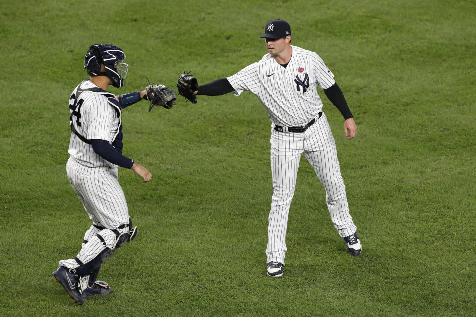 New York Yankees relief pitcher Zack Britton, right, and catcher Gary Sanchez celebrate after the Yankees defeated the Bostons Red Sox 4-2 in a baseball game, Sunday, Aug. 16, 2020, in New York. (AP Photo/Kathy Willens)