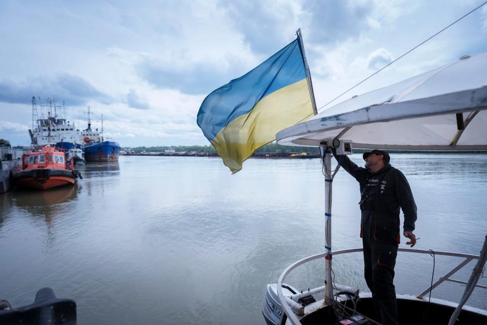 A sailor fixes the flag of Ukraine on a boat in Izmail southwest of Kiev on April 26, 2023.