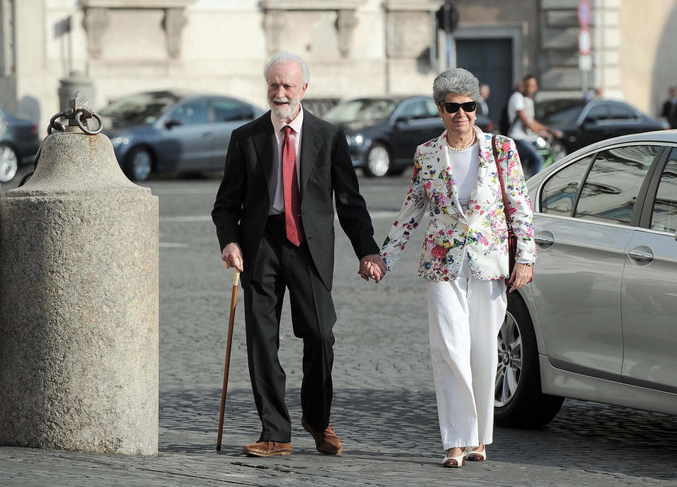 Italian journalist Eugenio Scalfari, left, walks with his wife Serena Rossetti as they arrive for an event at the Quirinale Presidential Palace on the eve of the celebrations for the Republic Day, in Rome, June 1, 2015. Scalfari, who revolutionized Italian journalism with the creation of La Repubblica, a liberal daily that boldly challenged traditional newspapers, died on Thursday, July 14, 2022, the Senate president announced. He was 98. (Fabio Cimaglia/LaPresse via AP)