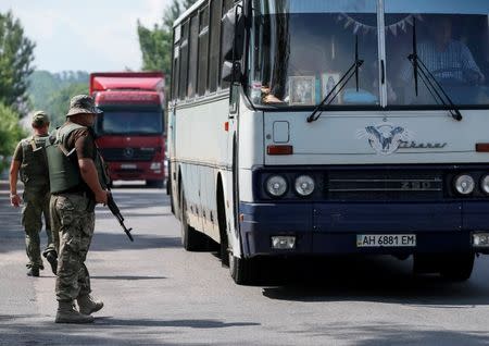 Ukrainian servicemen check cars at a checkpoint near Slaviansk in Donetsk region, Ukraine, June 29, 2016. Picture taken June 29, 2016. REUTERS/Gleb Garanich
