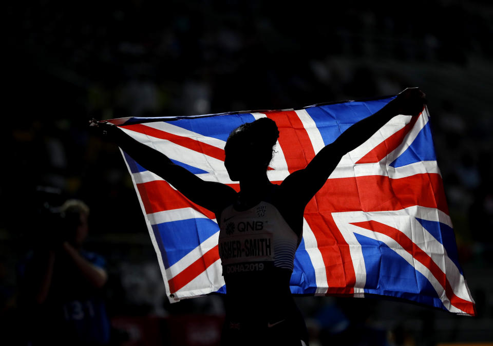 Dina Asher-Smith of Great Britain celebrates winning the gold medal in the women's 200 meter final at the World Athletics Championships in Doha, Qatar, Wednesday, Oct. 2, 2019. (AP Photo/Petr David Josek)