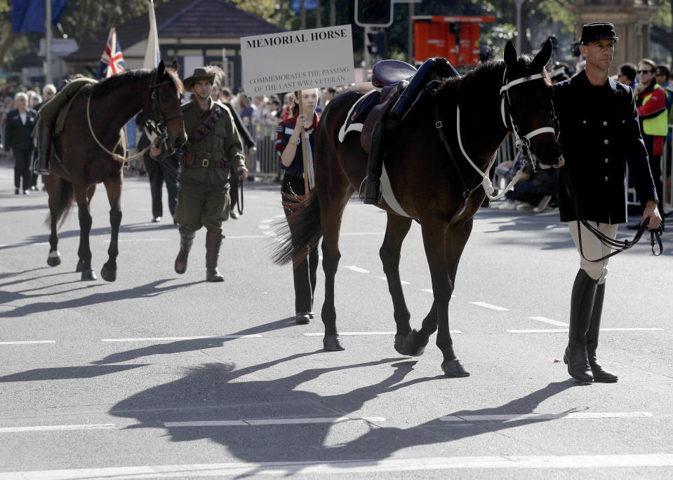 Riderless horses symbolizing fallen soldiers take part in a march celebrating ANZAC Day, a national day of remembrance in Australia and New Zealand that commemorates those that served and died in all wars, conflicts, and while peacekeeping, in Sydney, Australia, Thursday, April 25, 2019. (AP Photo/Rick Rycroft)