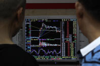 Investors monitor stock prices at a brokerage house in Beijing, Wednesday, May 22, 2019. Shares edged in Asia on Wednesday after a rebound in technology stocks helped power an overnight rally on Wall Street. (AP Photo/Andy Wong)