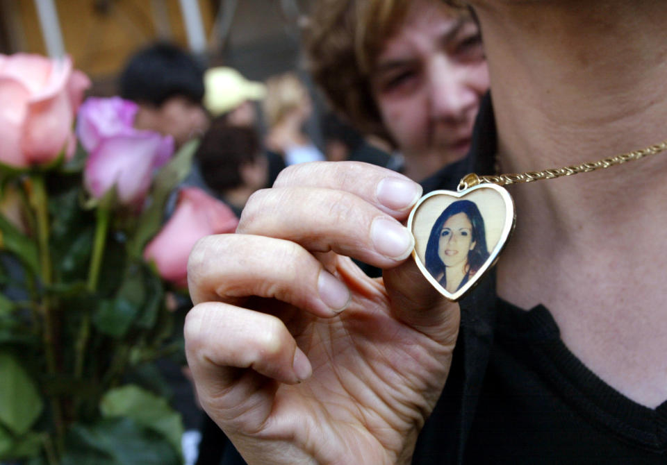 NEW YORK - SEPTEMBER 11:   A relative wears a necklace near Ground Zero with a picture of Daniela Notaro, killed in the World Trade Center attacks a year ago, September 11, 2002 in New York City.  (Photo by Mario Tama/Gettty Images) 